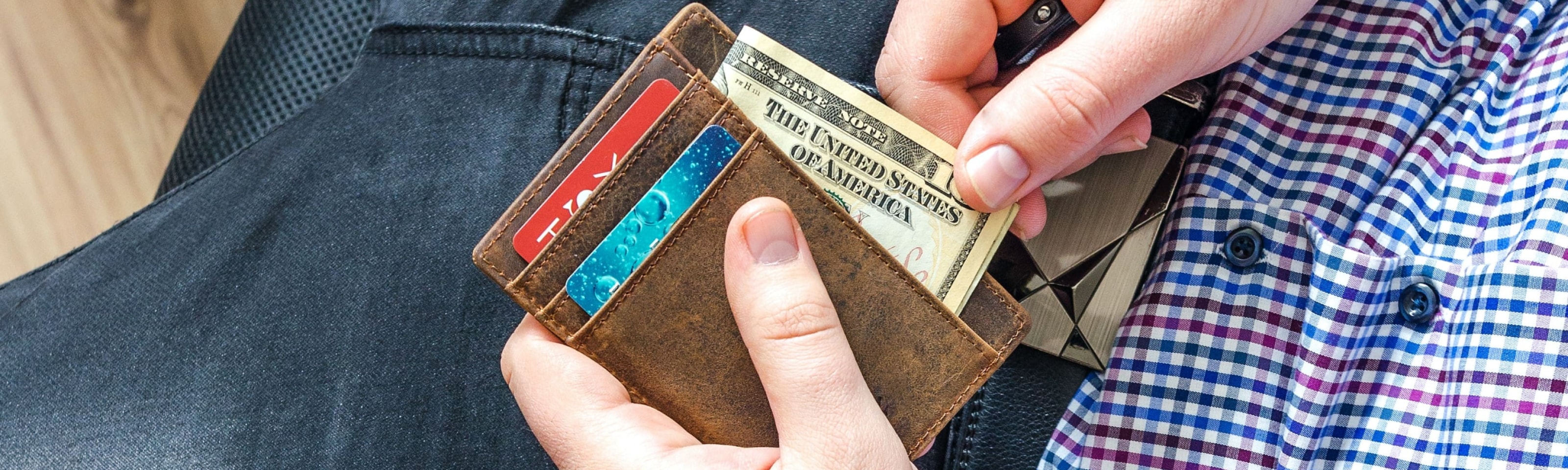 Man sitting down taking money out of wallet