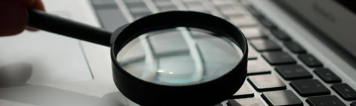 A magnifying glass over a laptop keyboard